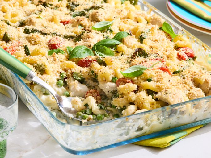 Chicken Primavera Pasta Bake in a glass dish with serving spoon